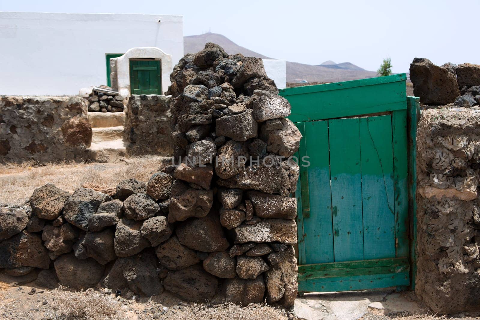 Lanzarote typical rural white house green door in Canary Islands