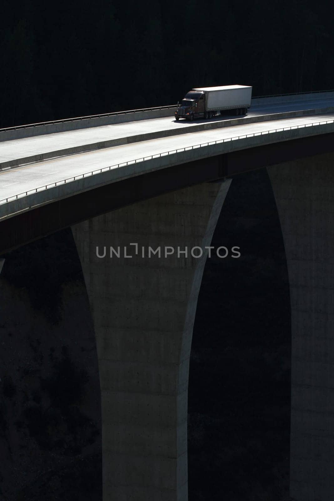 Semi trailer truck crossing a high level bridge in British Columbia, Canada
