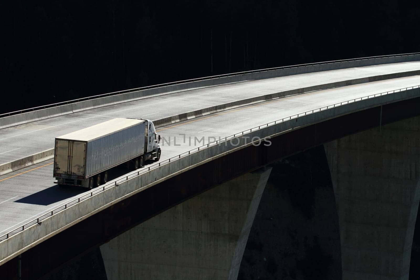 Semi trailer truck crossing a high level bridge in British Columbia, Canada