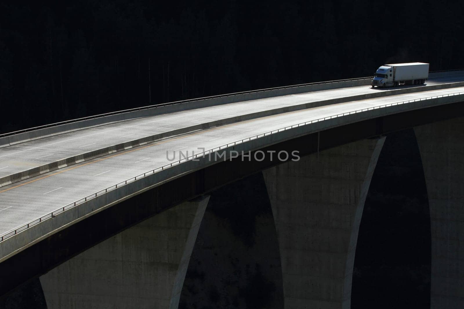 Semi trailer truck crossing a high level bridge in British Columbia, Canada