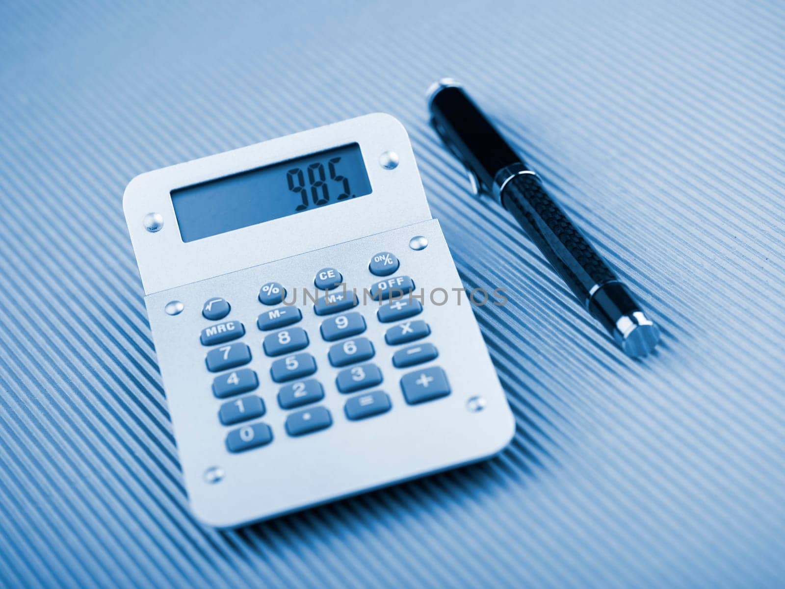 Calculator and pen on office table