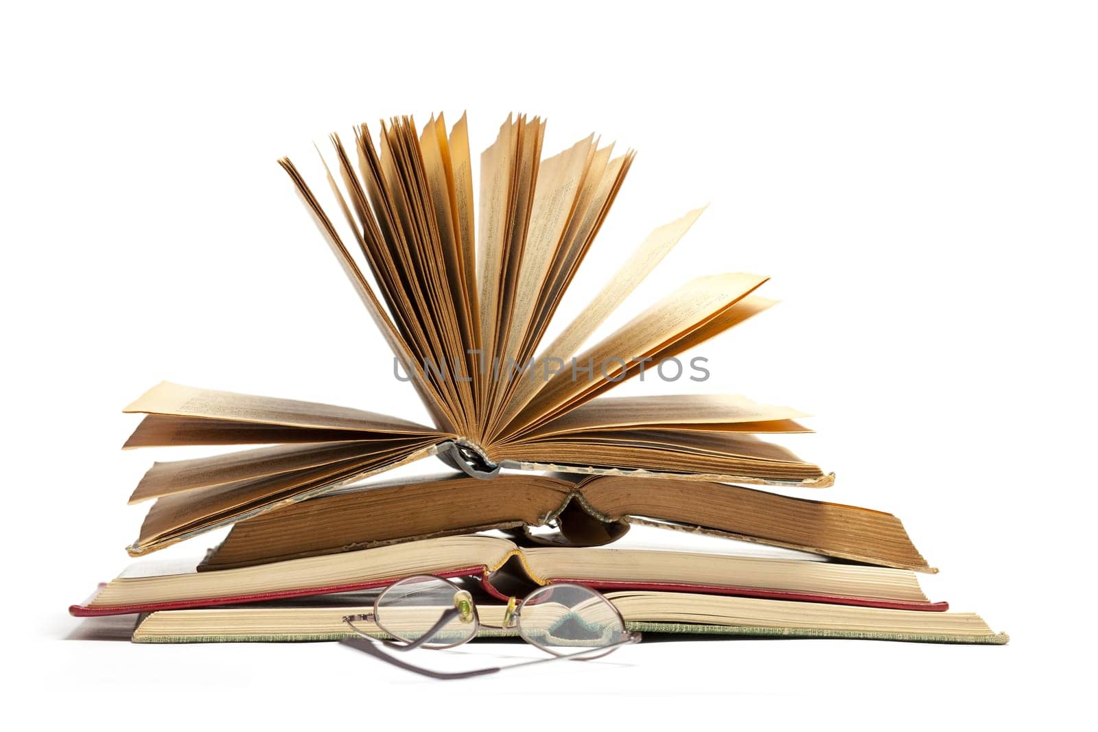 Open Old Antique Books and Eyeglasses isolated on white