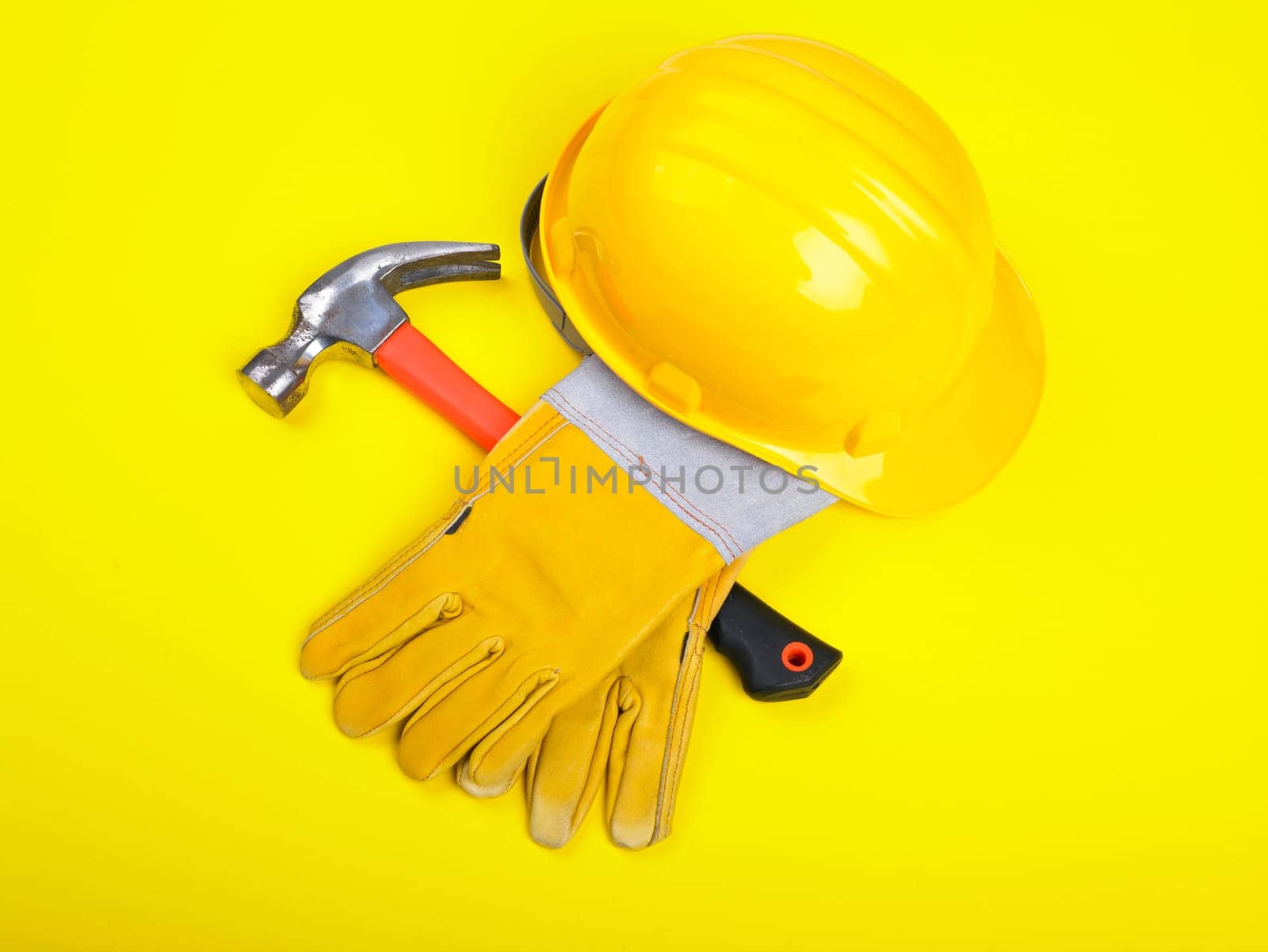 Worker equipment - HardHat Hammer And Gloves on yellow
