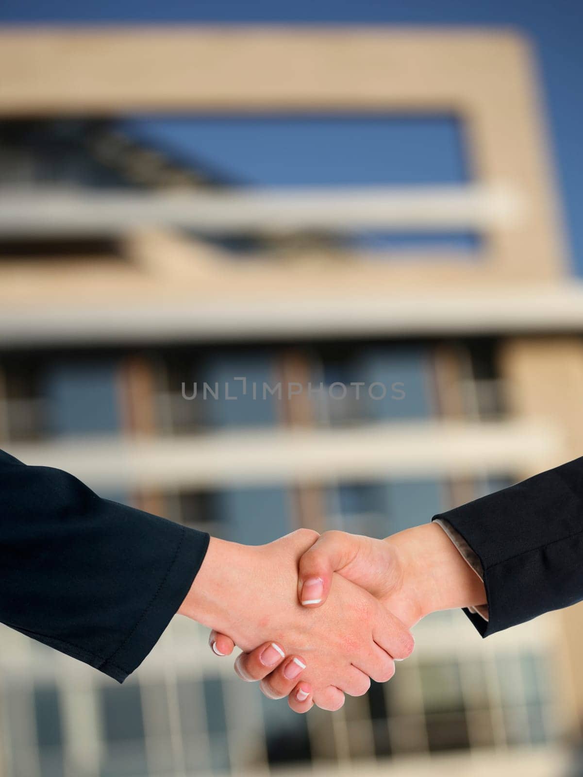 Handshake Handshaking and blured building in background