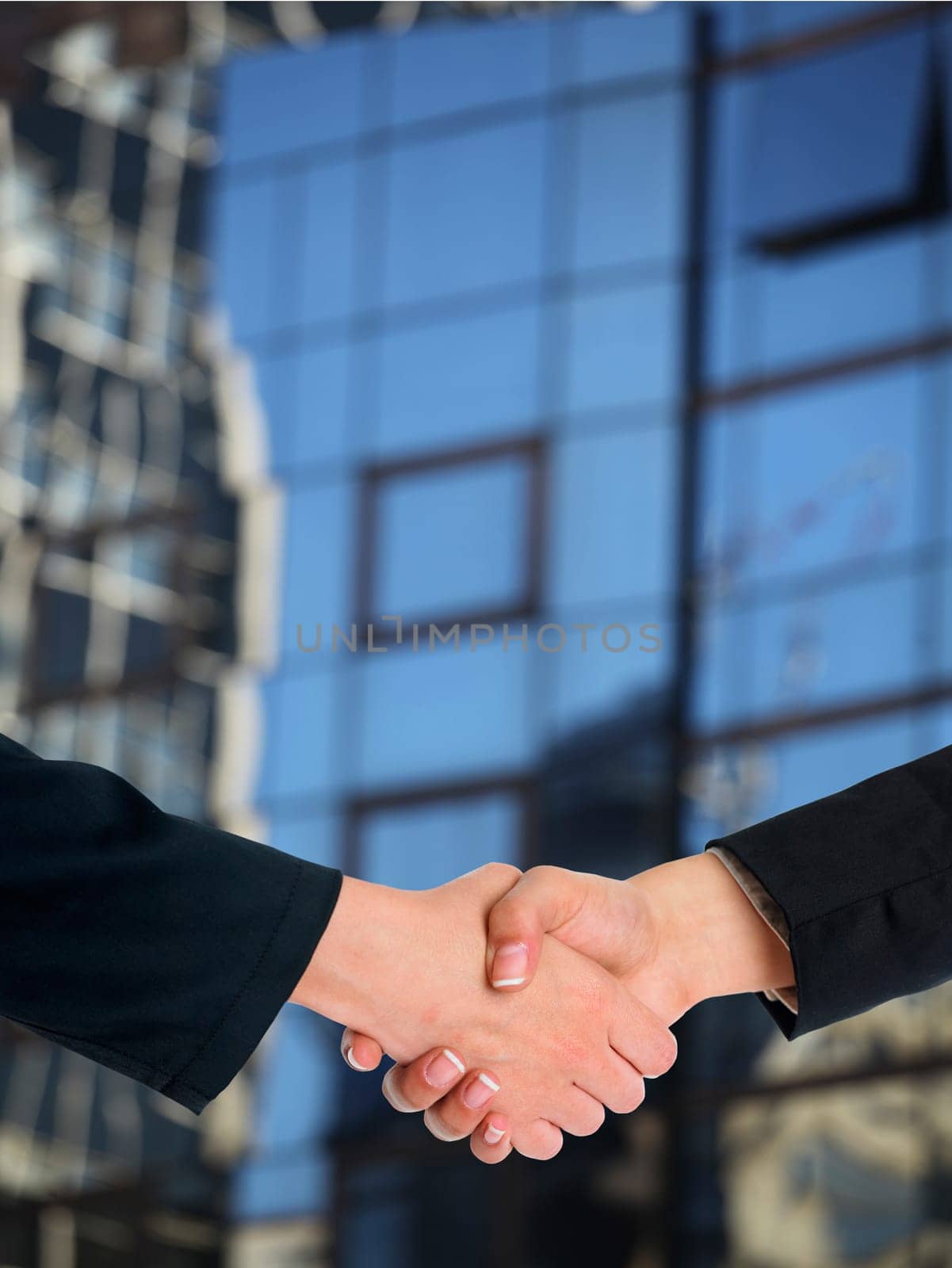 Handshake Handshaking and blured building in background