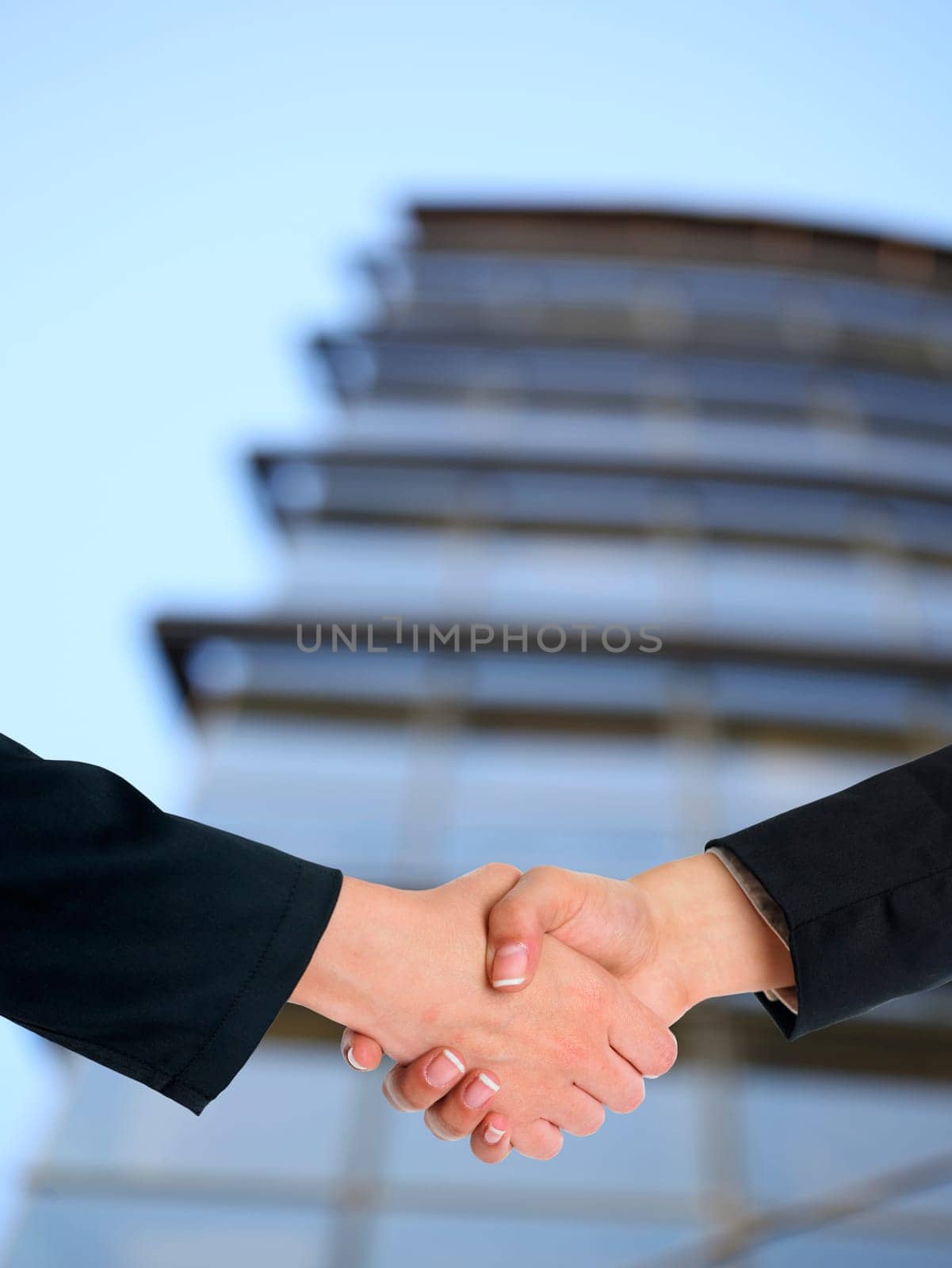 Handshake Handshaking and blured building in background