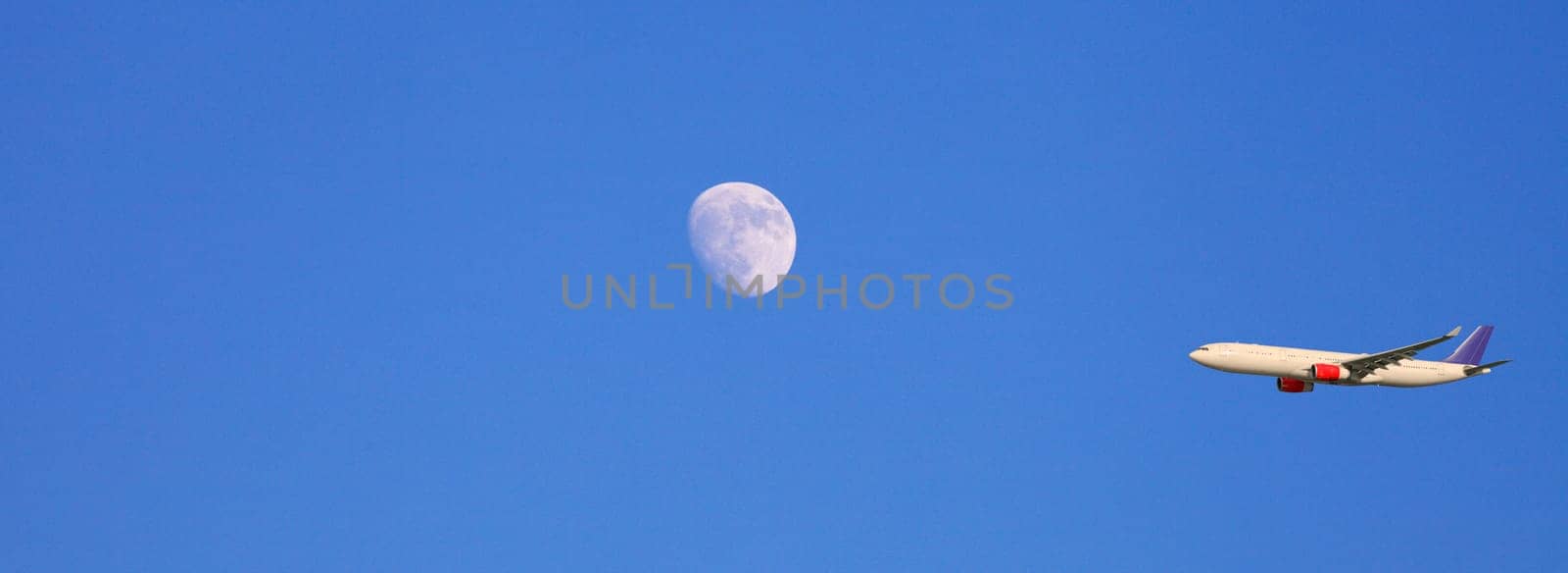 airplane, airliner flying past the moon, panoramic view