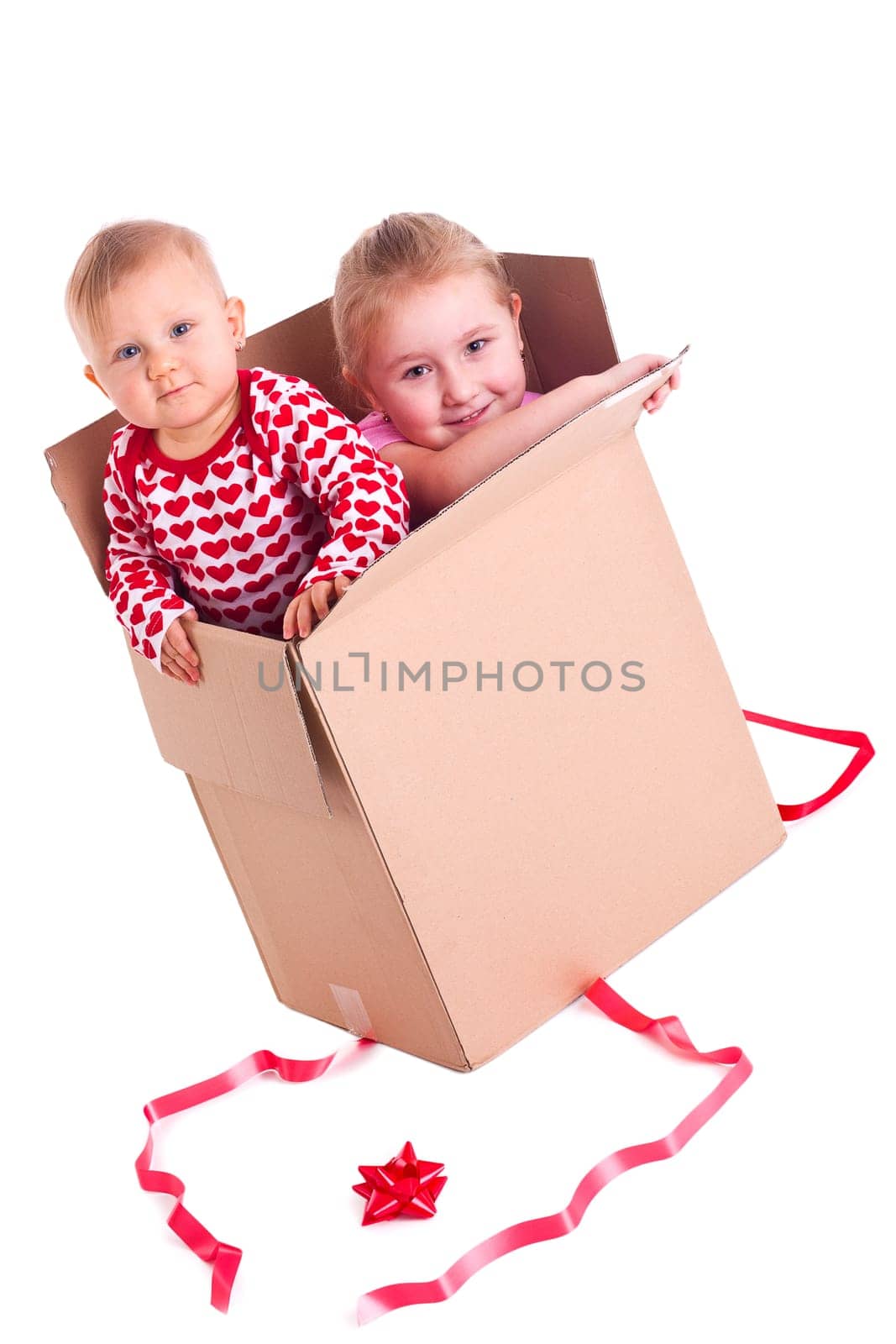 studio shot of two child in gift box