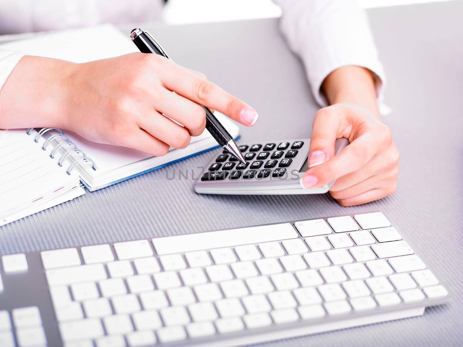Office business woman calculating with calculator and pencil