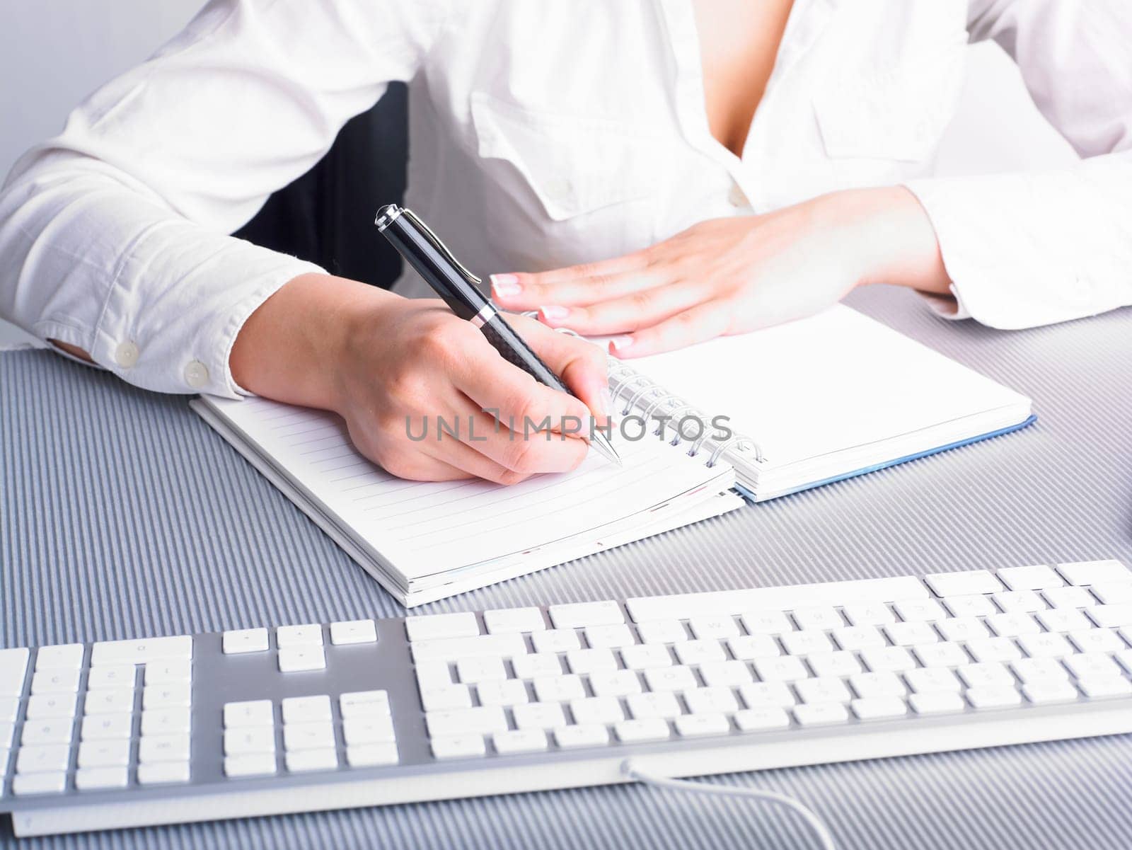 Office Assistant in white writing Schedule