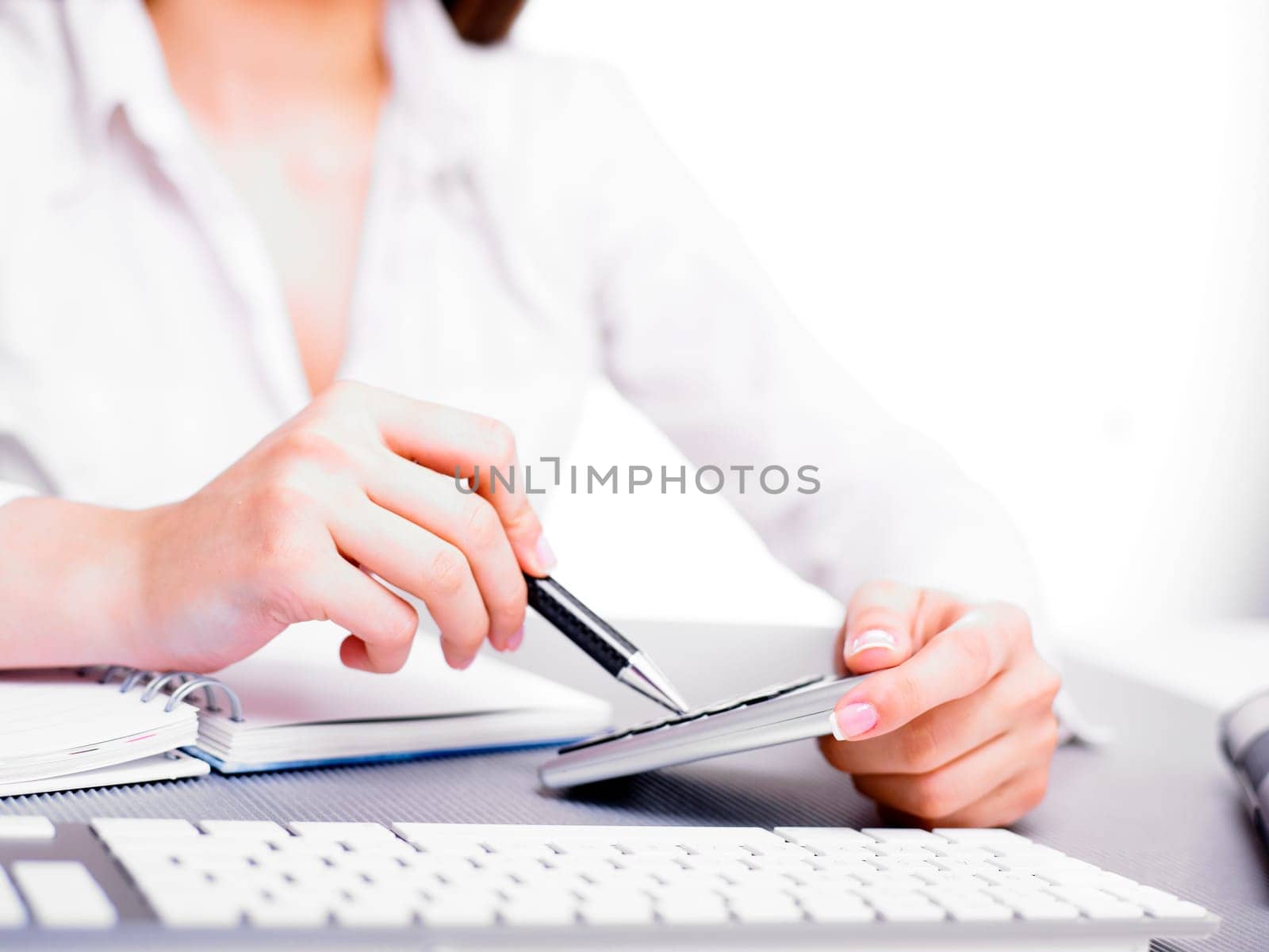 Office business woman calculating with calculator and pencil