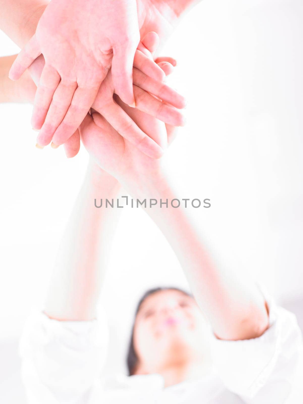 Business team join hands on white background