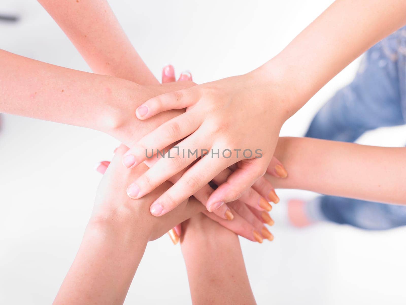 Business team join hands on white background