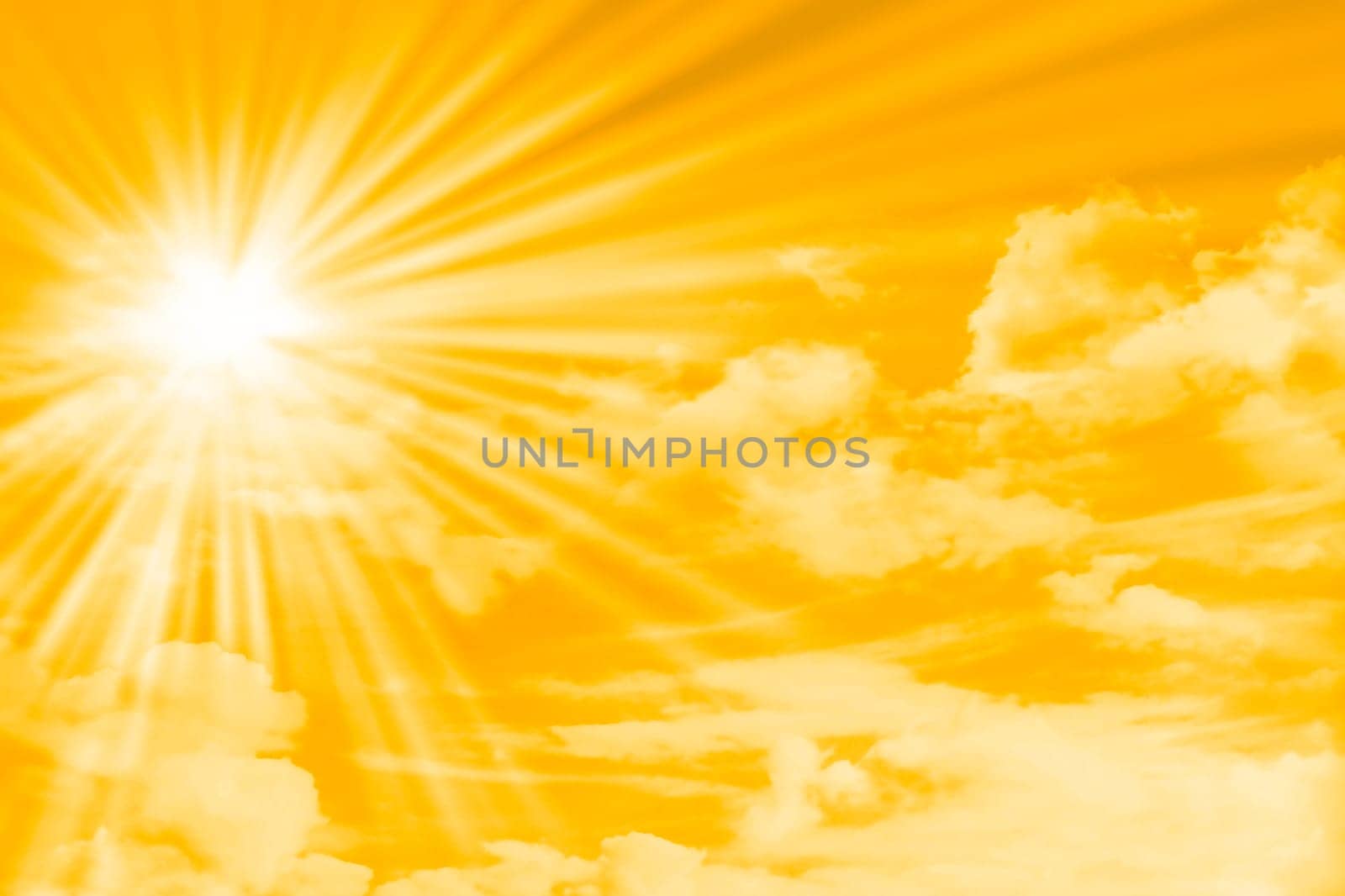 yellow sky with clouds, sun and sun rays