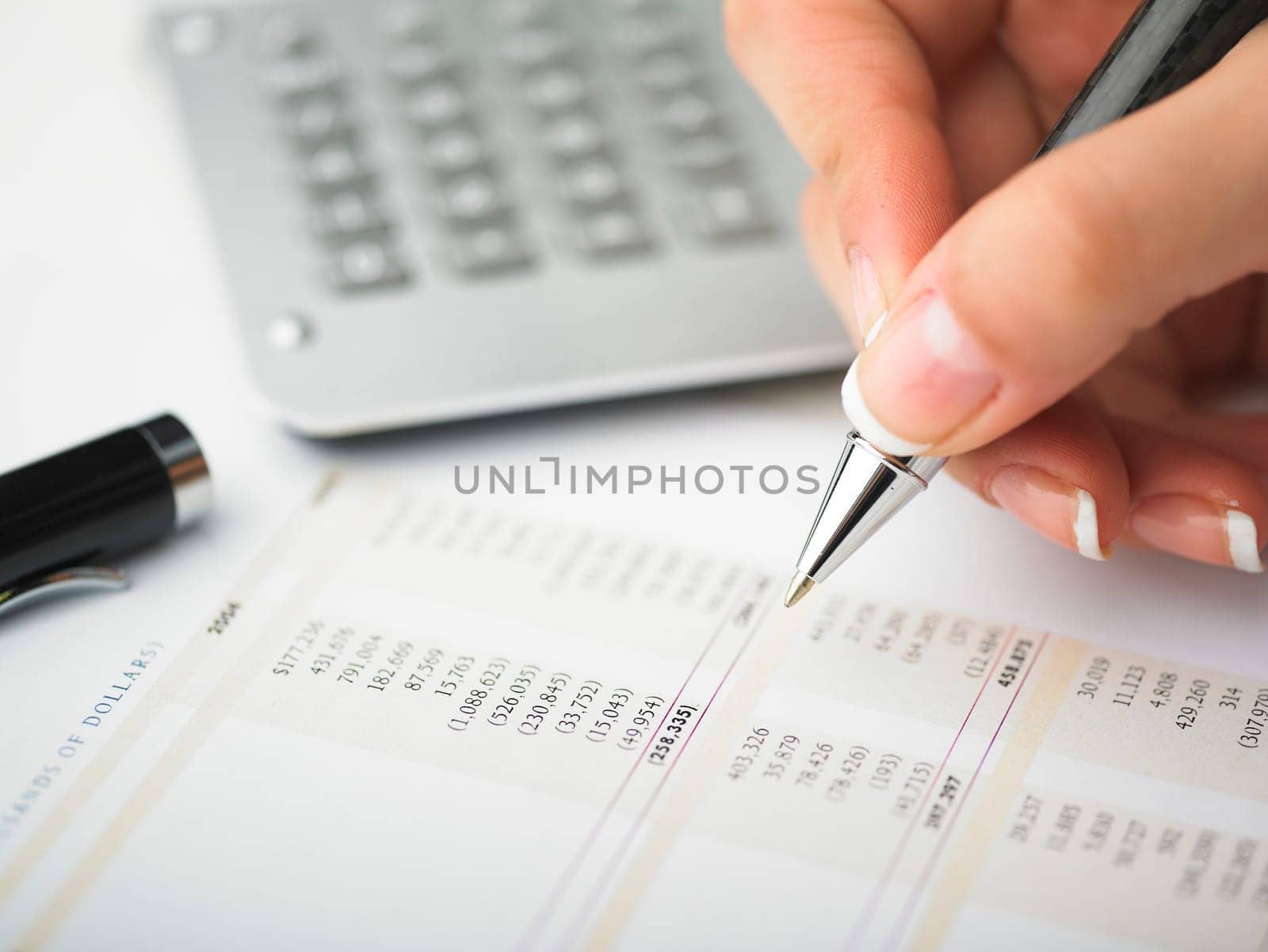 Market Analyze - pen and calculator on papers