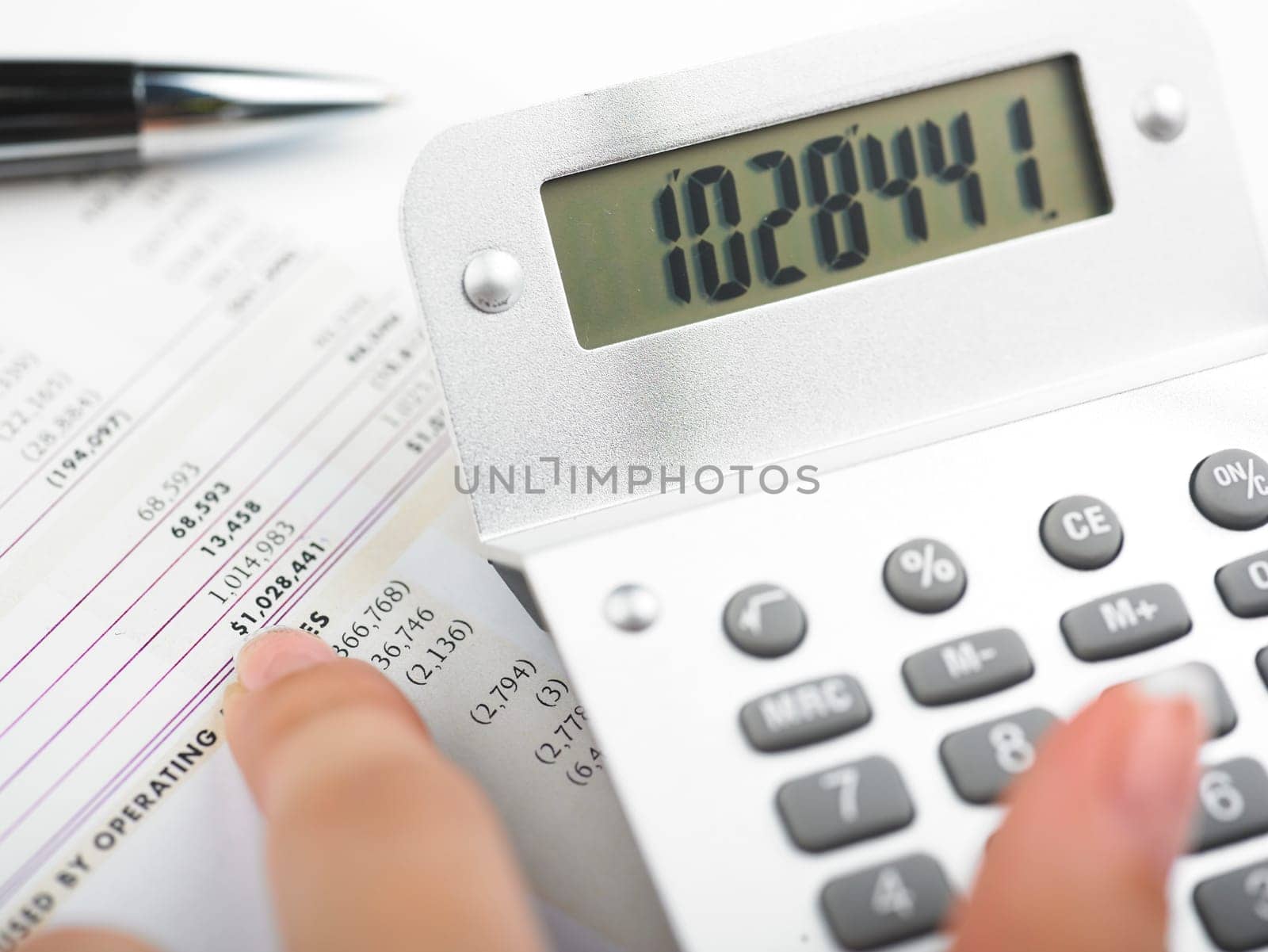 Market Analyze - pen and calculator on papers