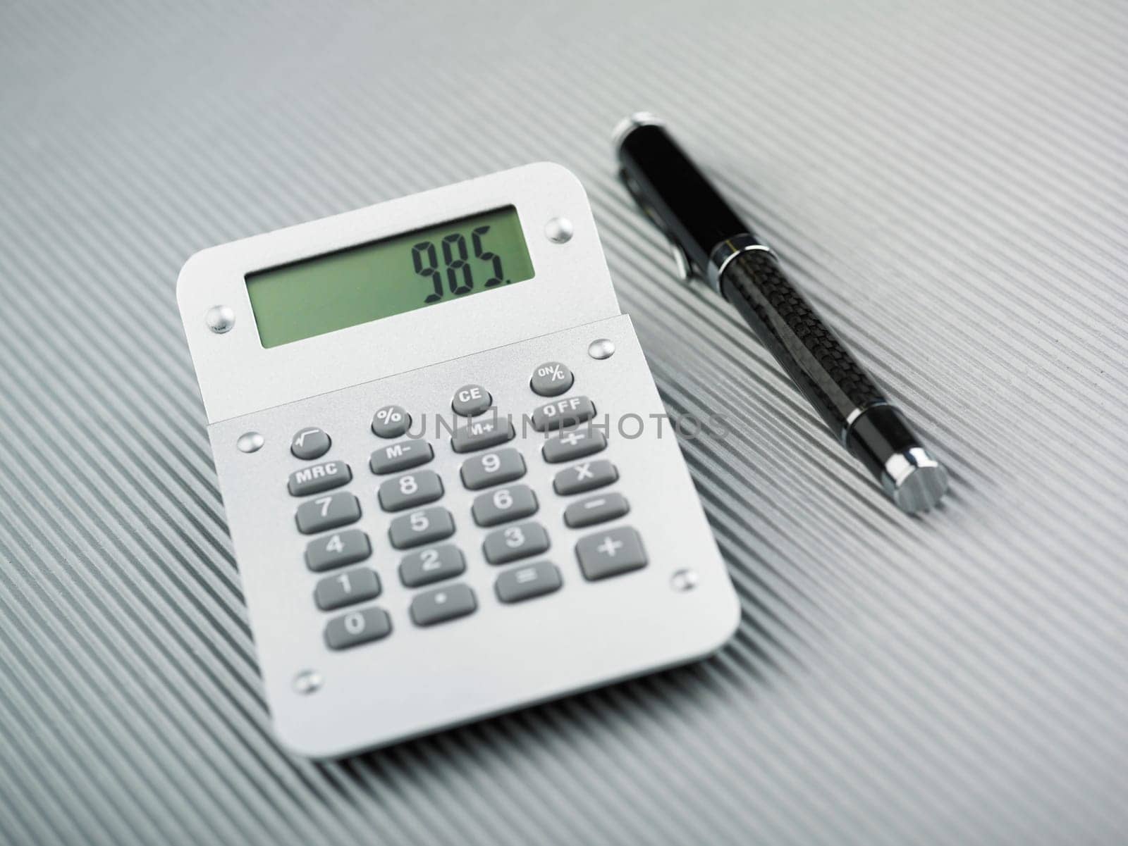 Calculator and pen on office table