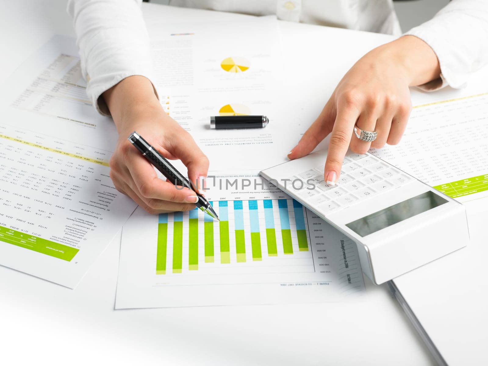 Market Analyze - pen and calculator on papers