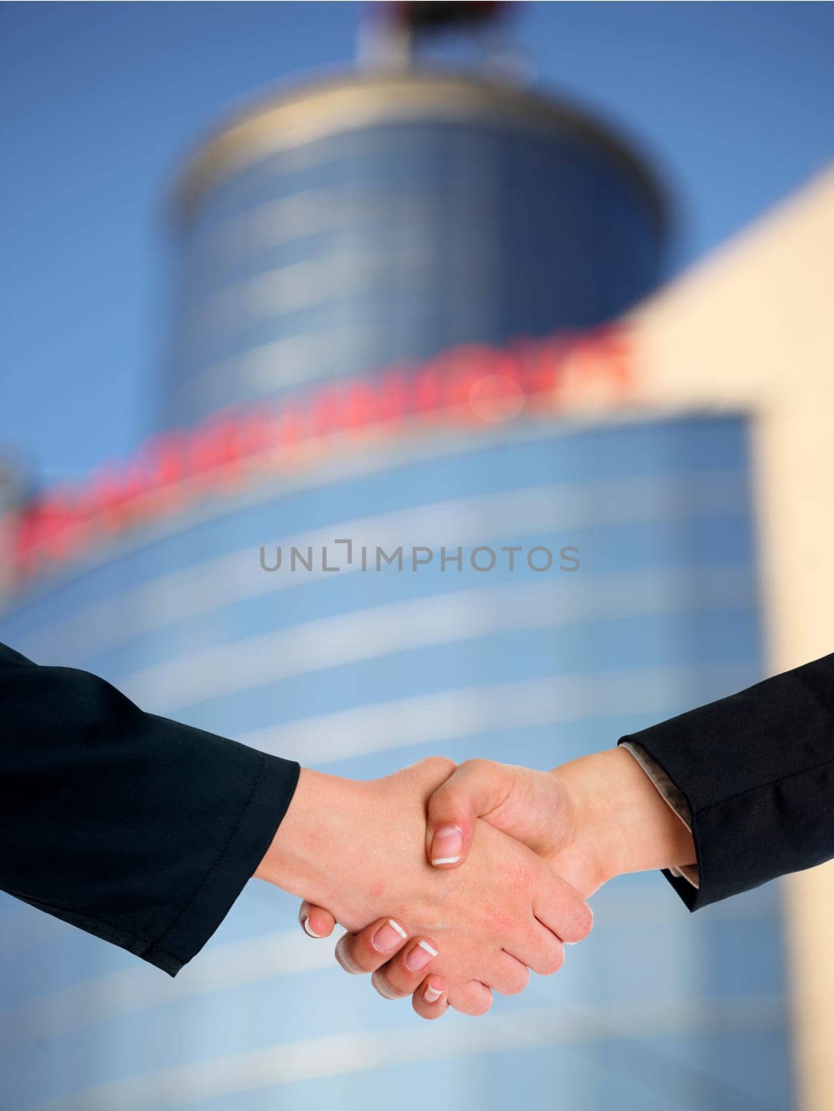Handshake Handshaking and blured building in background