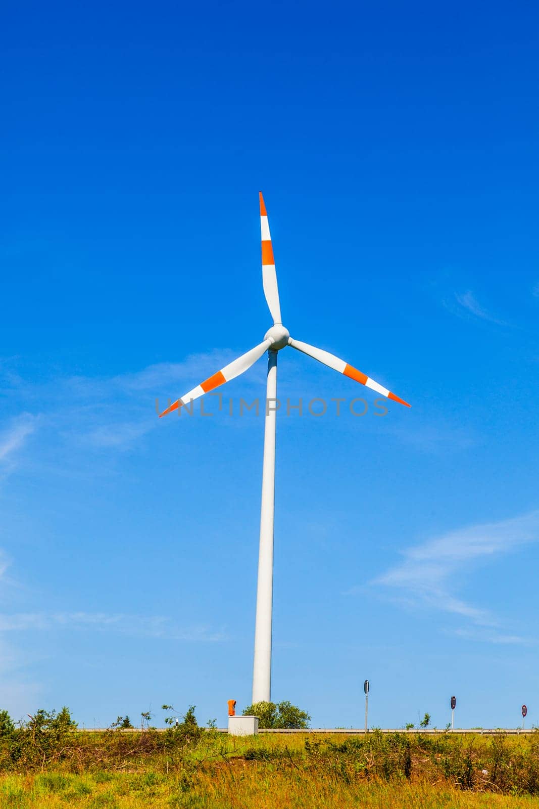 Windmill gathers energy from the summer breeze.