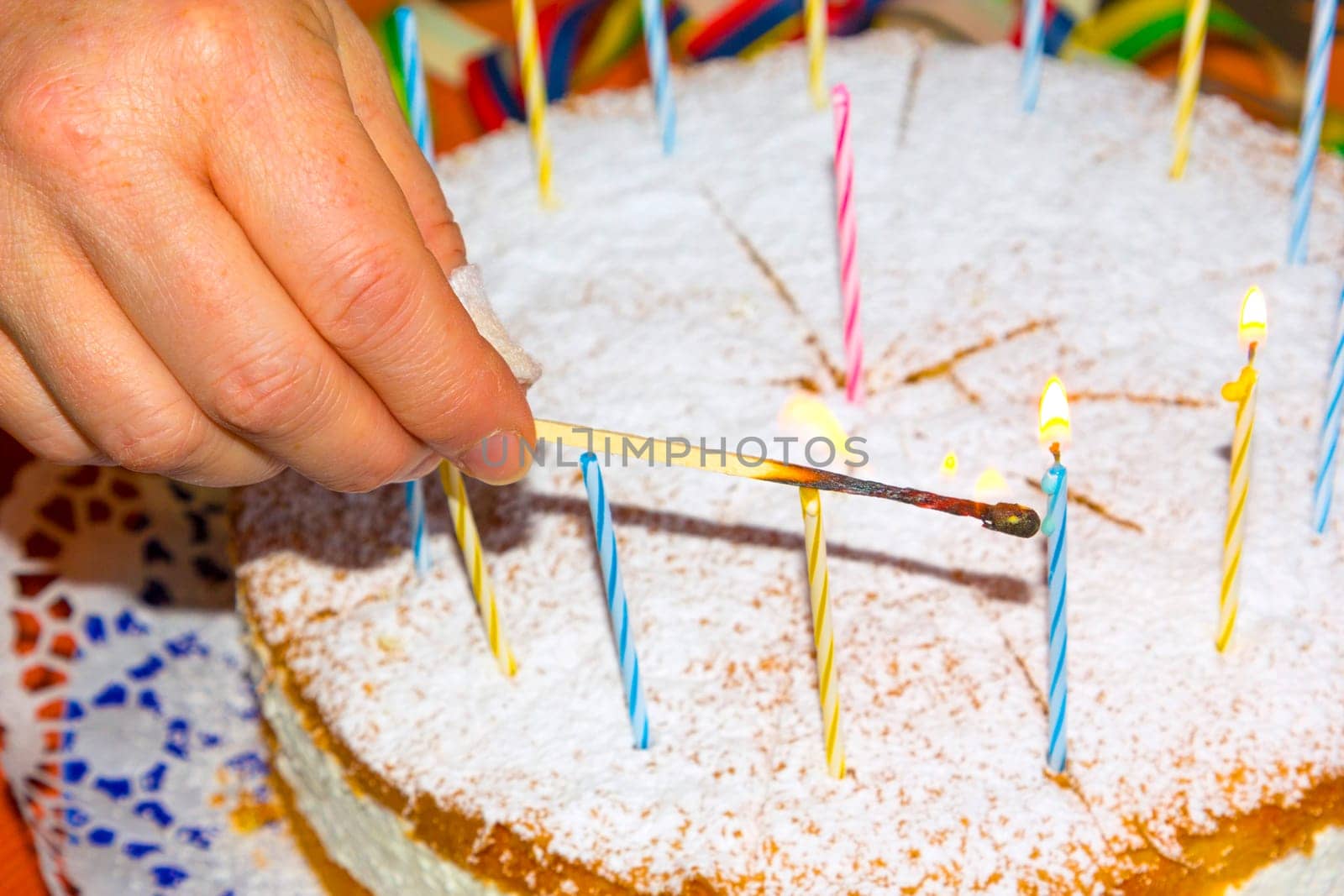 lighting the birthday candles on the cake