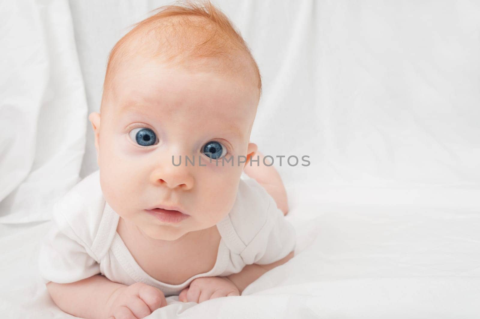 Newborn Baby Lying on Front on White Background