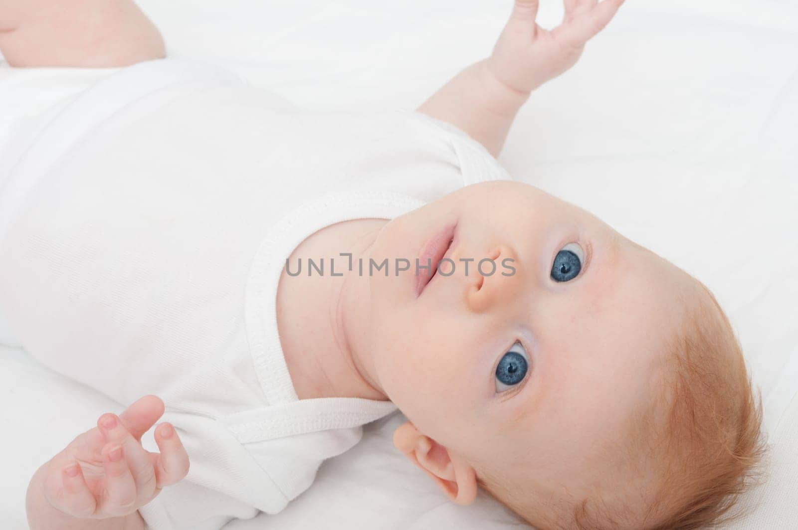Newborn Baby Lying on Back on White Background