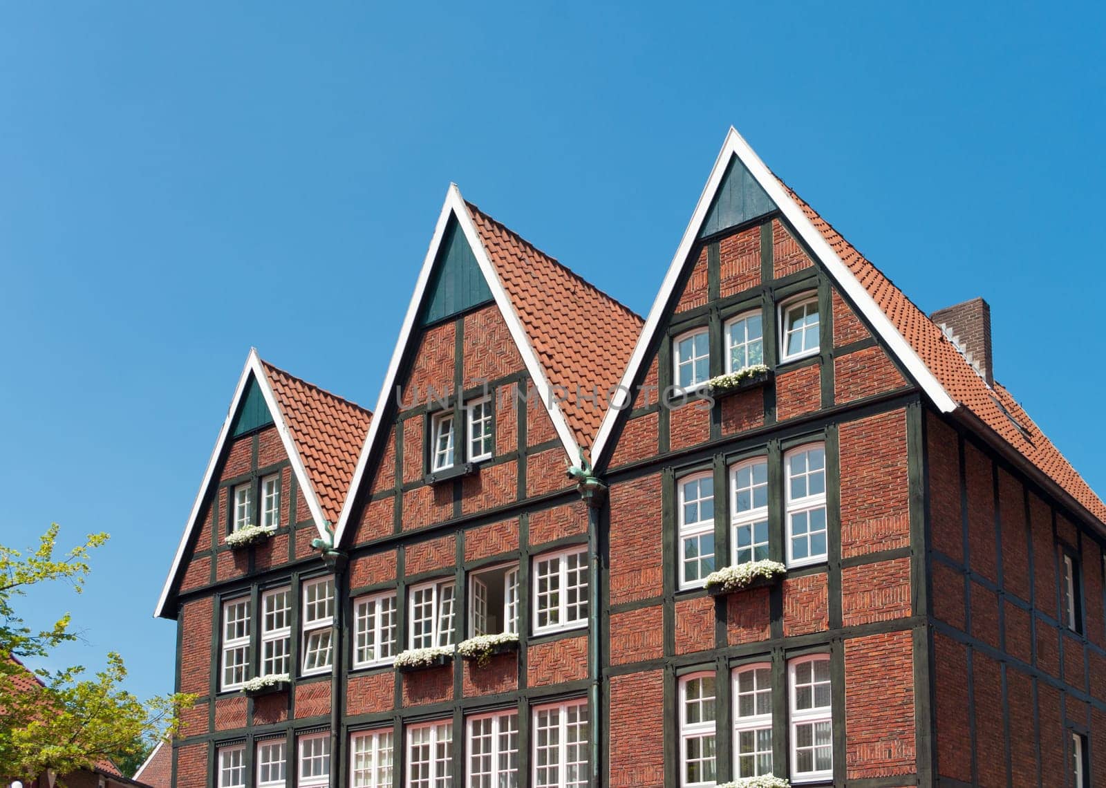 typical half-timbered German house with flower planters outside the windows