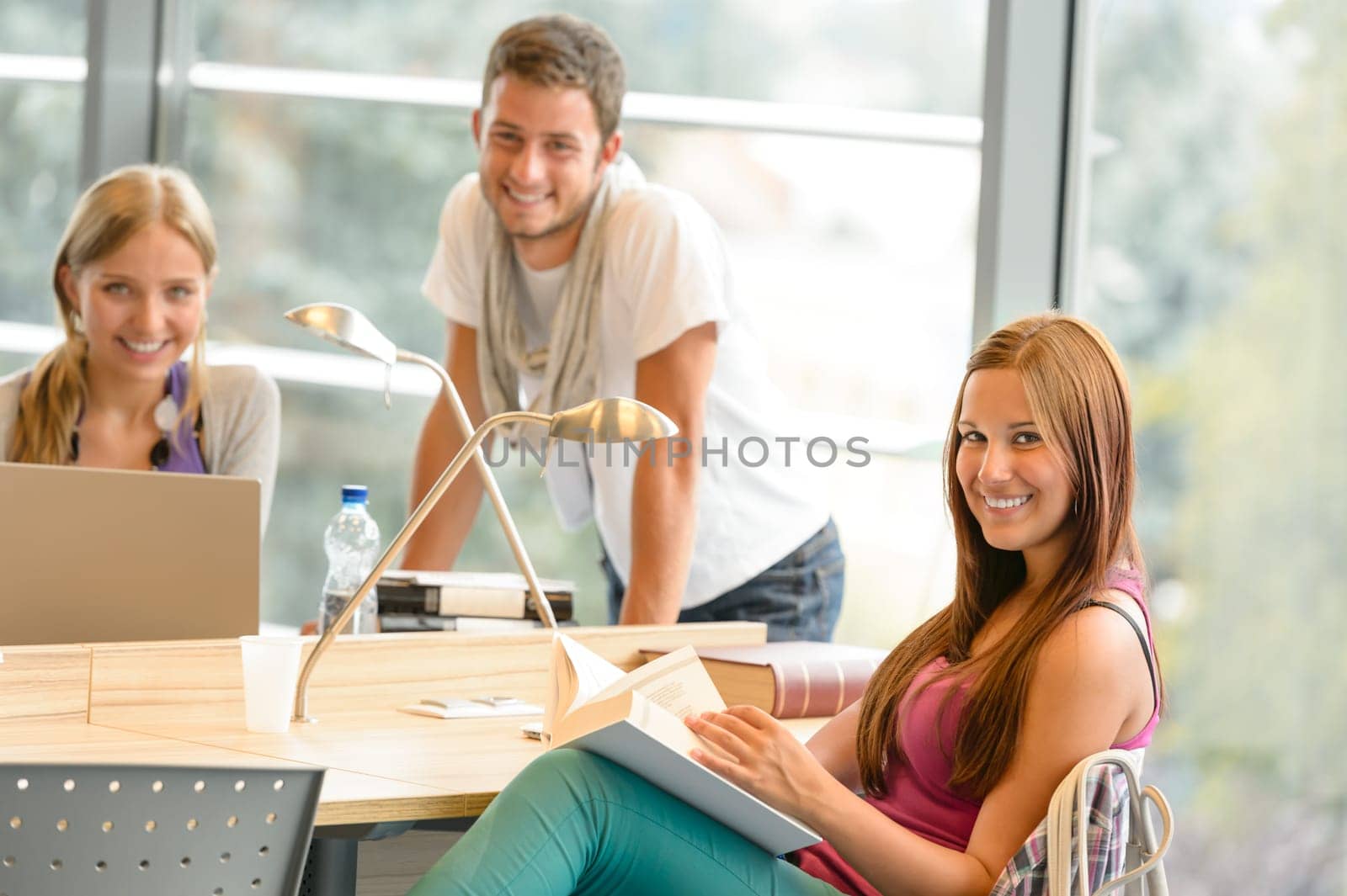 Back to school students studying in library smiling learning education