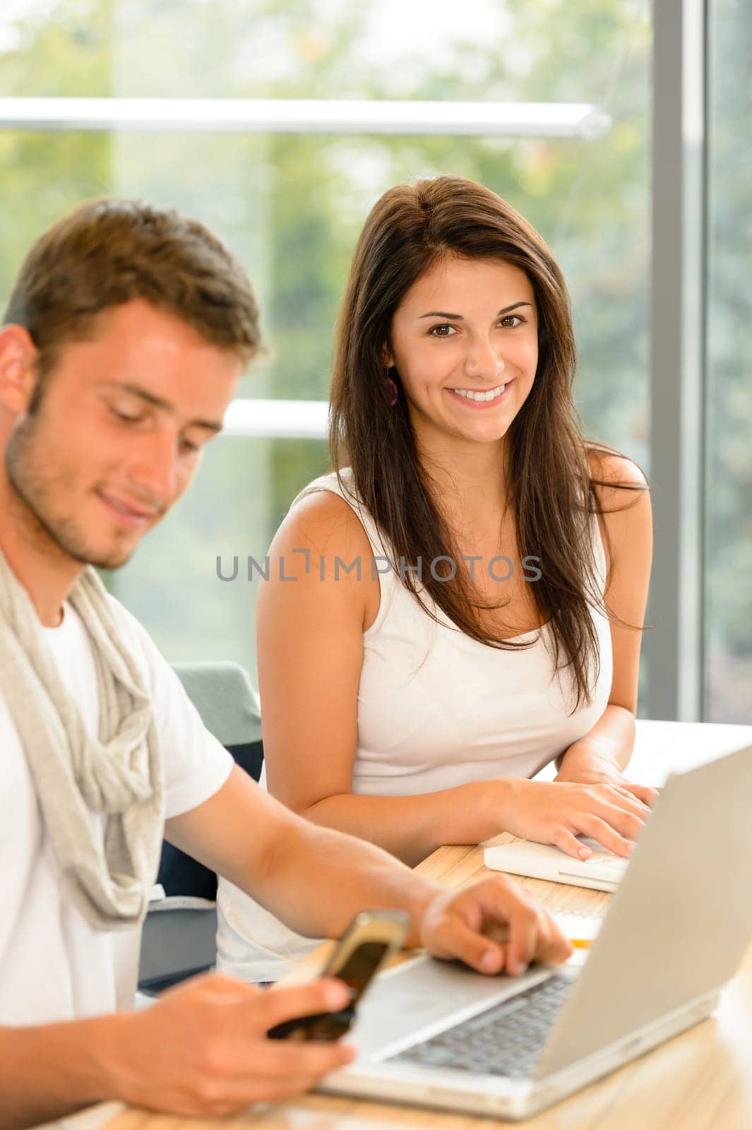 High-school students working on laptops in study academic library campus