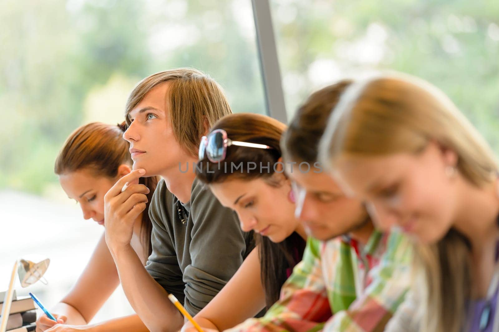 High-school student thinking at exam class teens writing college study