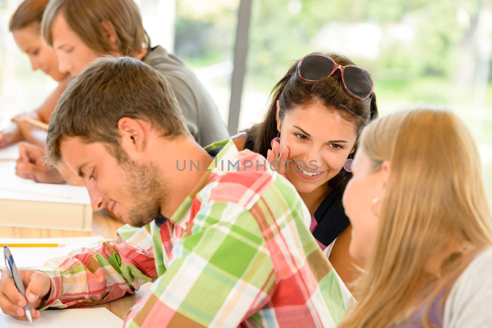 Pupils gossiping behind colleague's back in school class college teens
