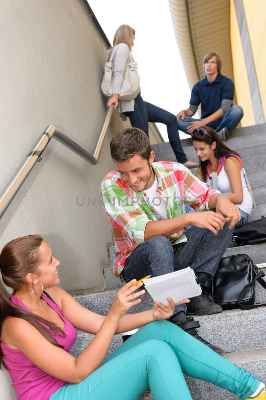 Students talking relaxing on school steps teens break smiling campus