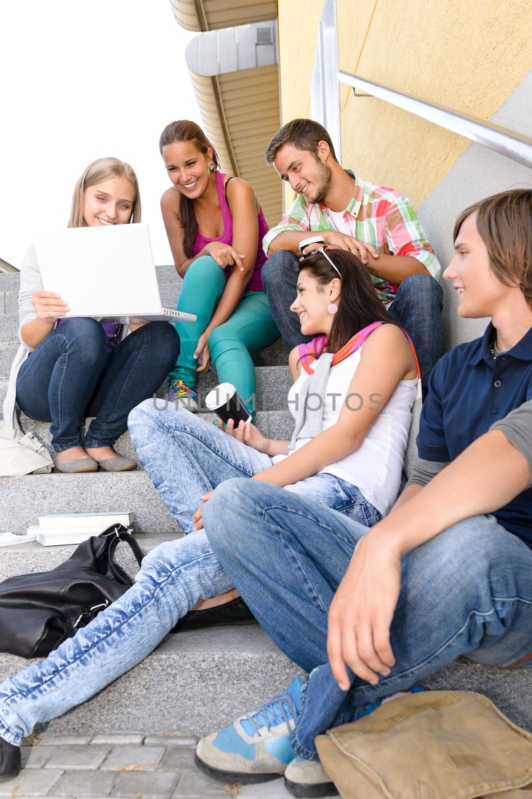 Students having fun with laptop school stairs teens college laughing
