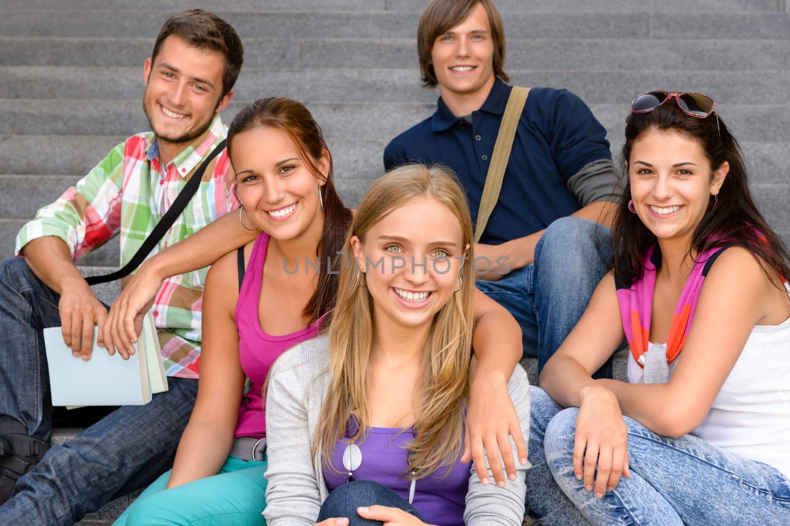 Students sitting on school stairs smiling teens campus college friends