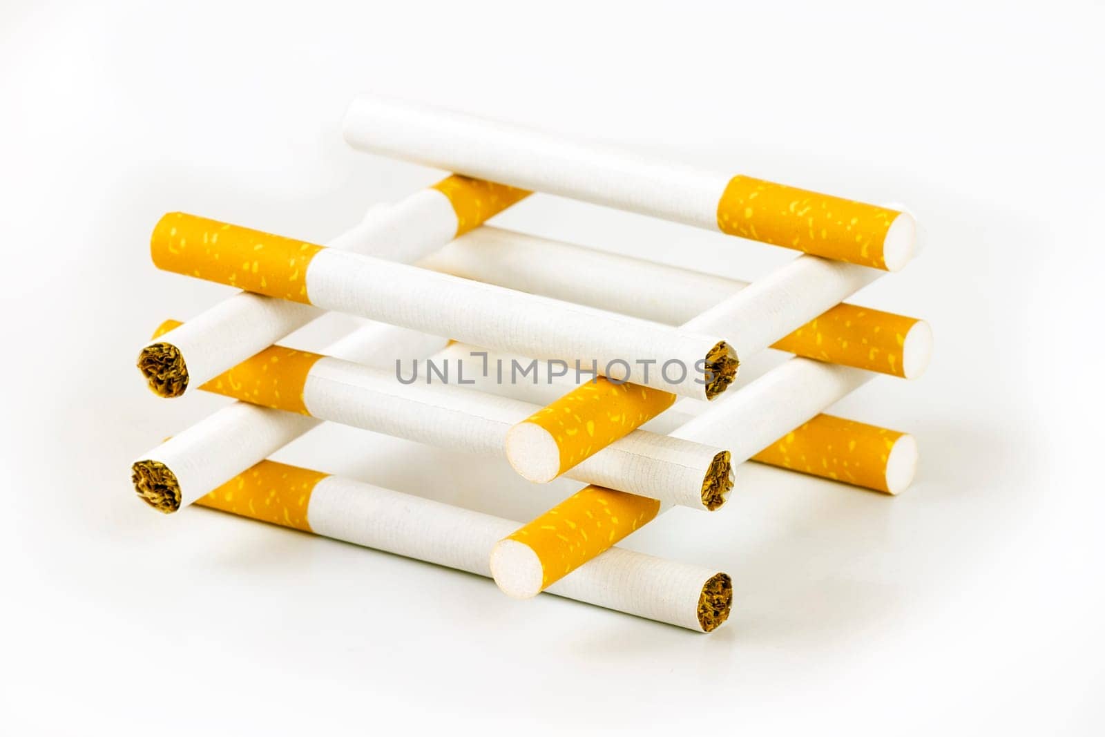 Color photo of filter cigarettes isolated background, forming a house.