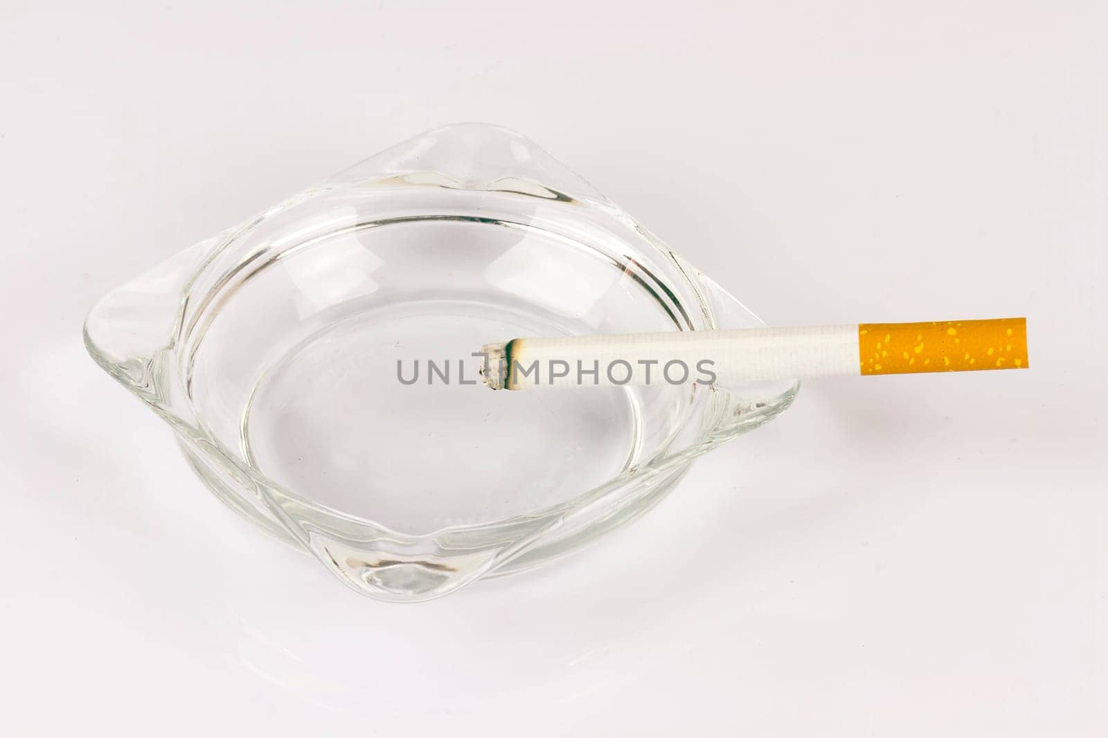 Color photo of filter cigarettes isolated background in an ashtray