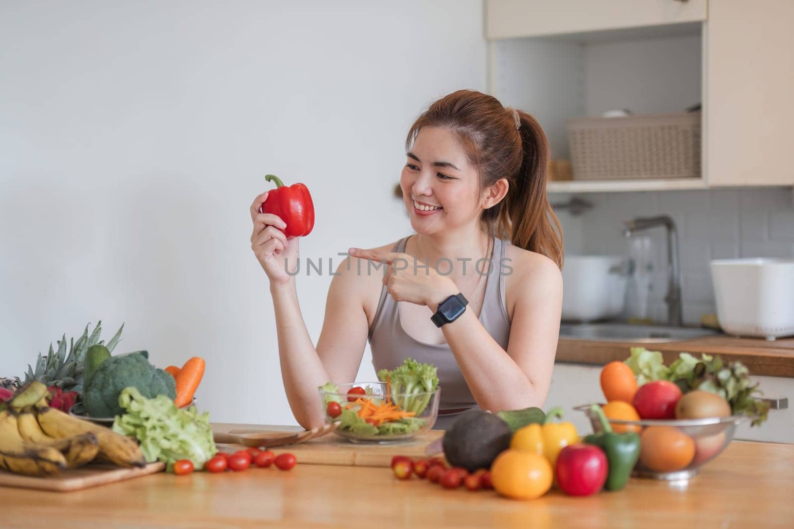 Sporty young woman is preparing healthy food on light kitchen. healthy food concept..