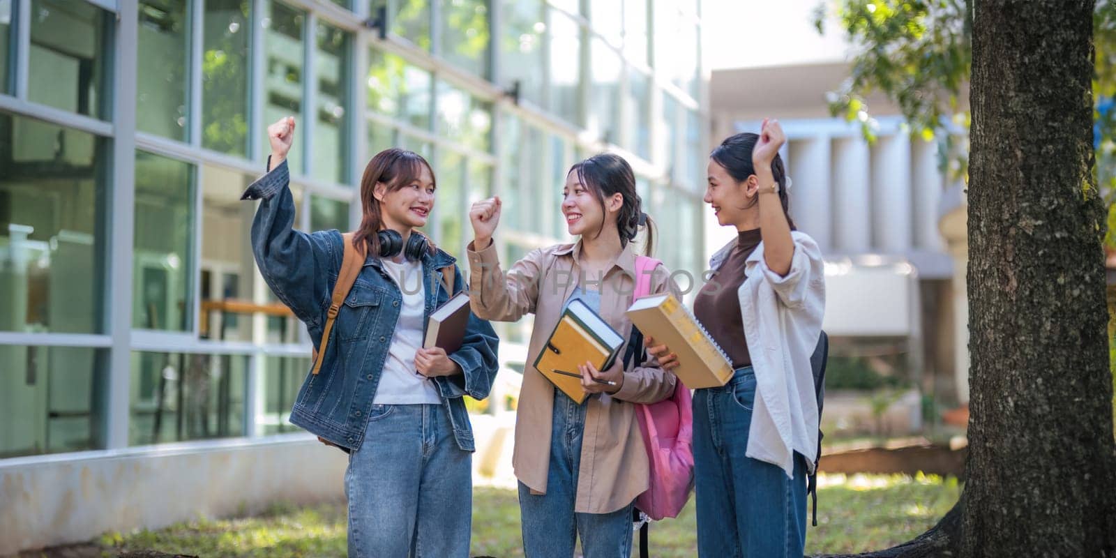 Student university friendship concept with classmate walking together at campus college park. Youth teenage and education by nateemee