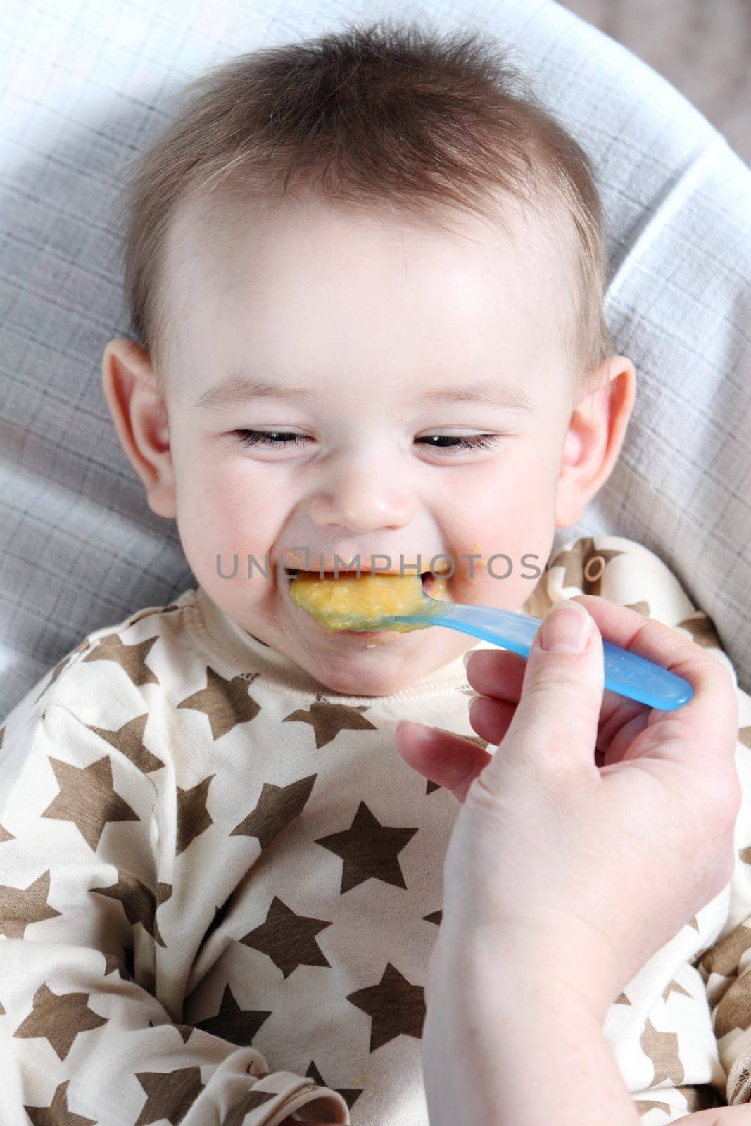 Baby boy eating vegetable mash