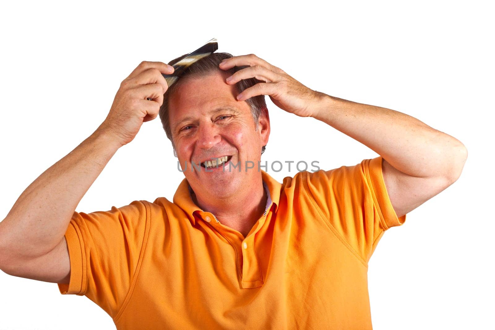 attractive man combing his hair in the studio