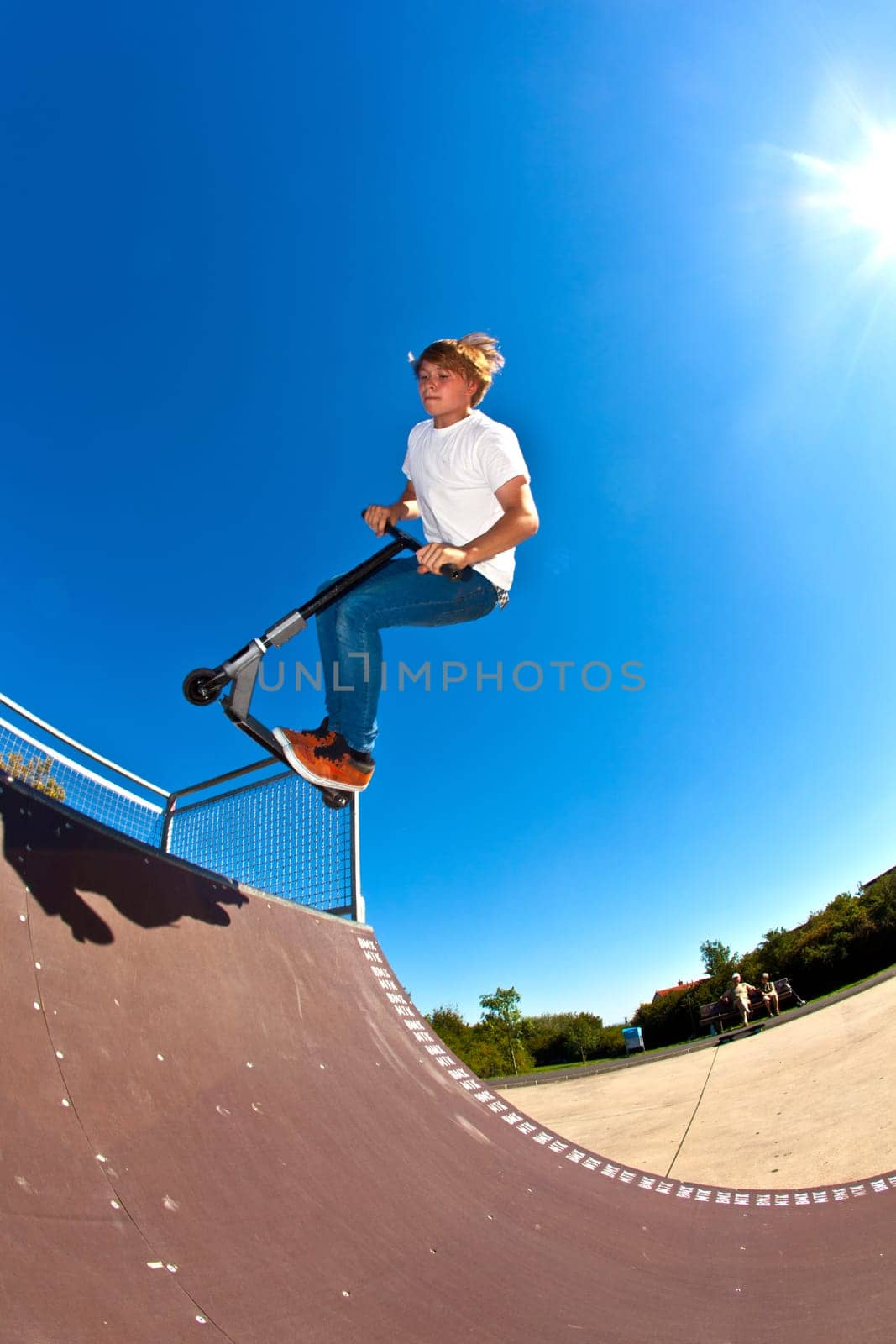 boy jumping with his scooter