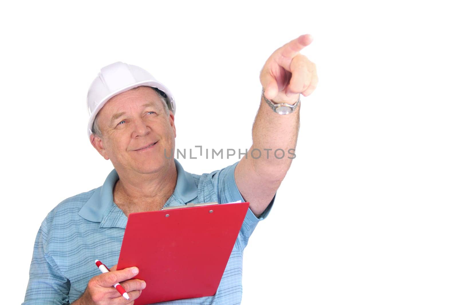 Middle aged construction foreman with hard hat pointing and smiling.