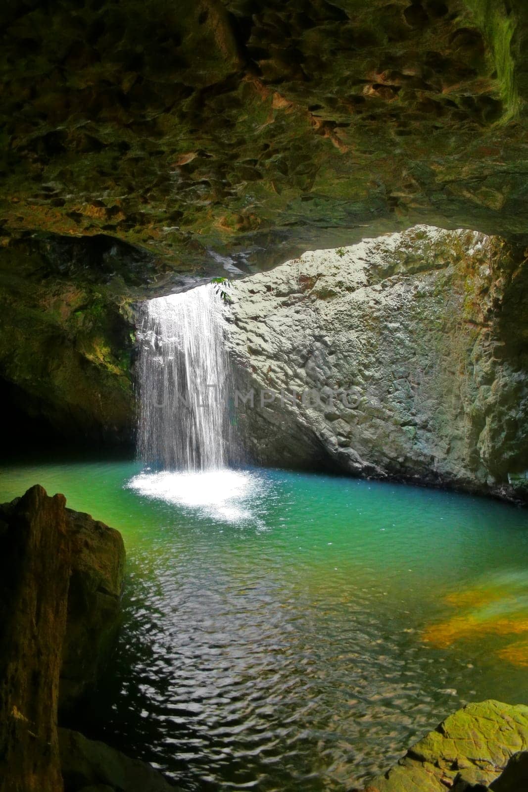 The waterfall at Natural Arch in Springbrook National Park in the Gold Coast hinterland in Queensland Australia.