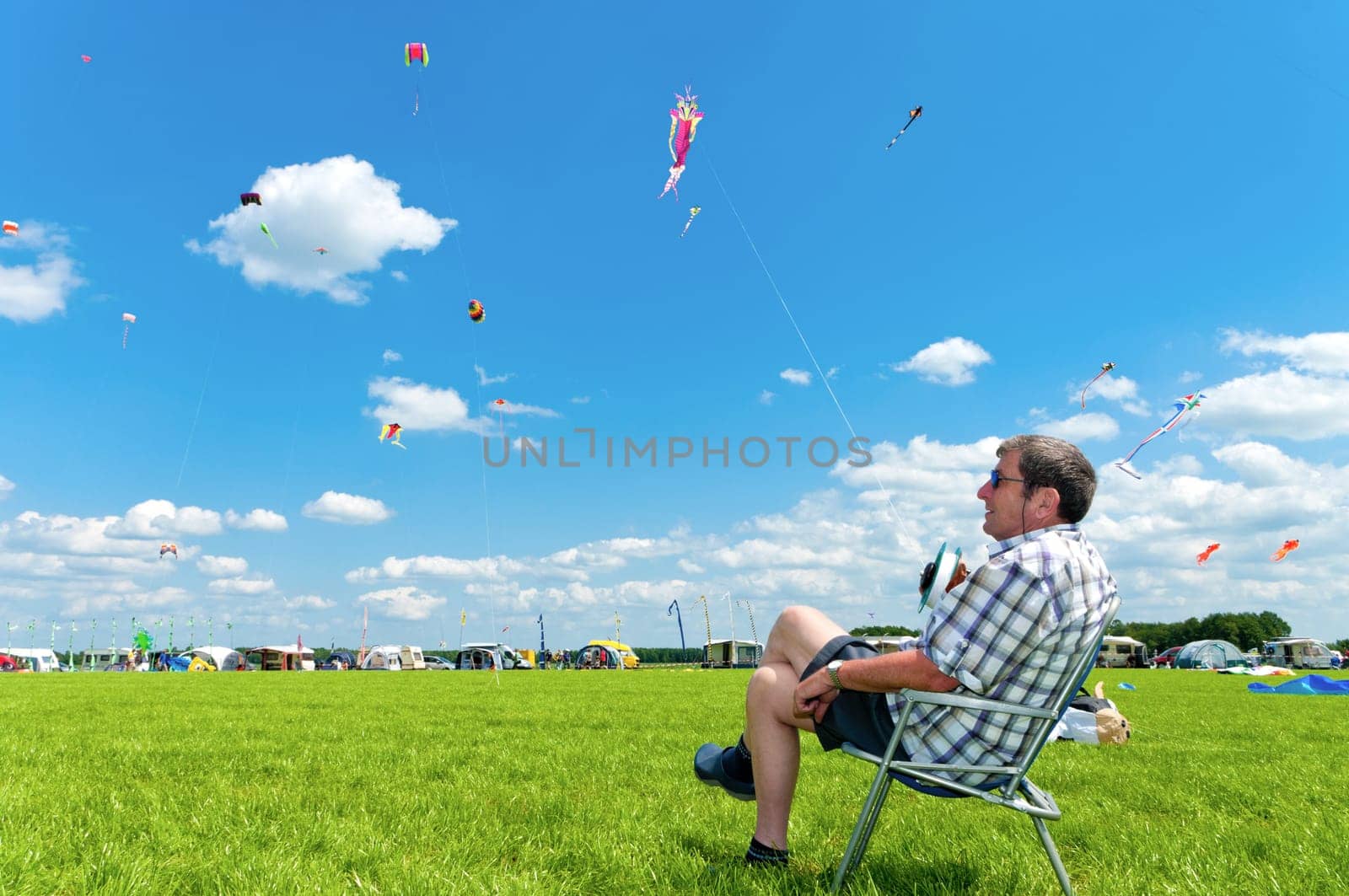 Man holding his kite at the 3rd international kite festival in Twenterand, Netherlands with a lot of participants from Germany and Belgium.