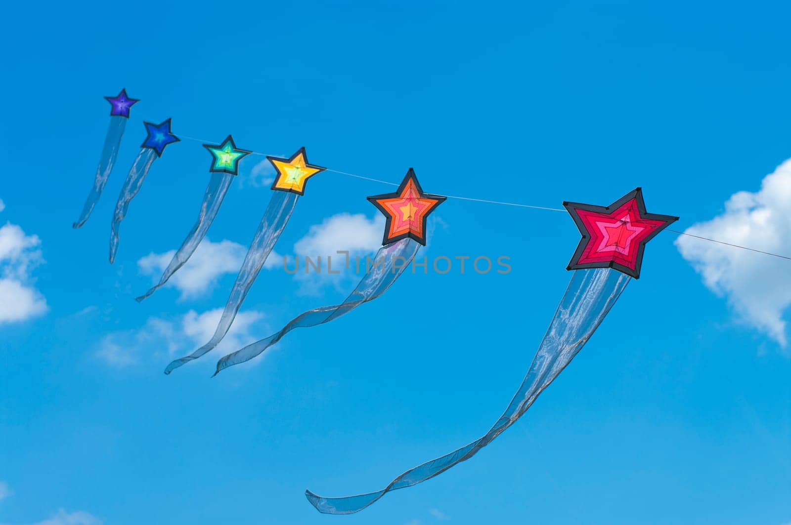 string of colorful star kites during the 3rd international kite festival in Twenterand, Netherlands