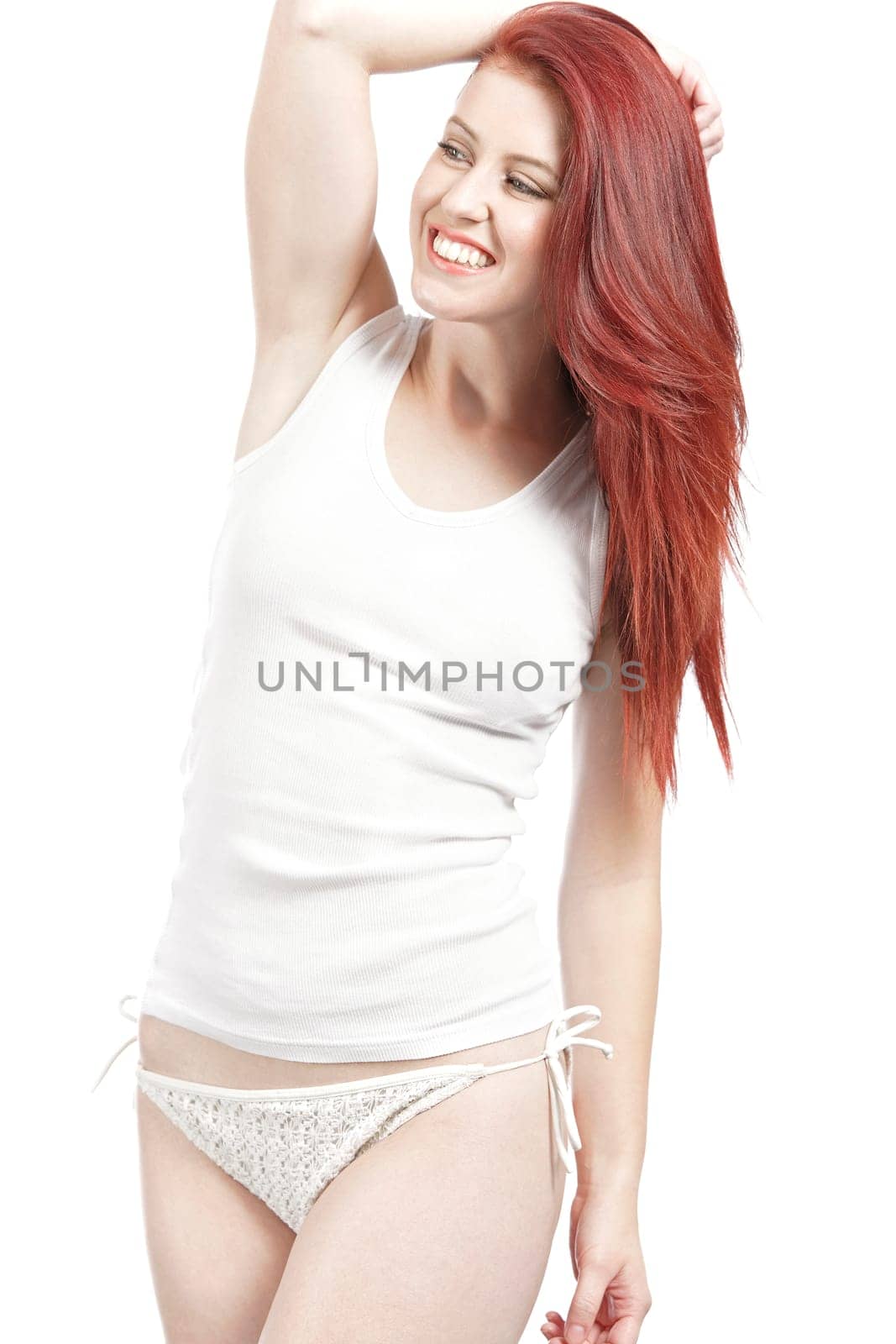 Attractive woman in white bikini bottoms and vest top posing