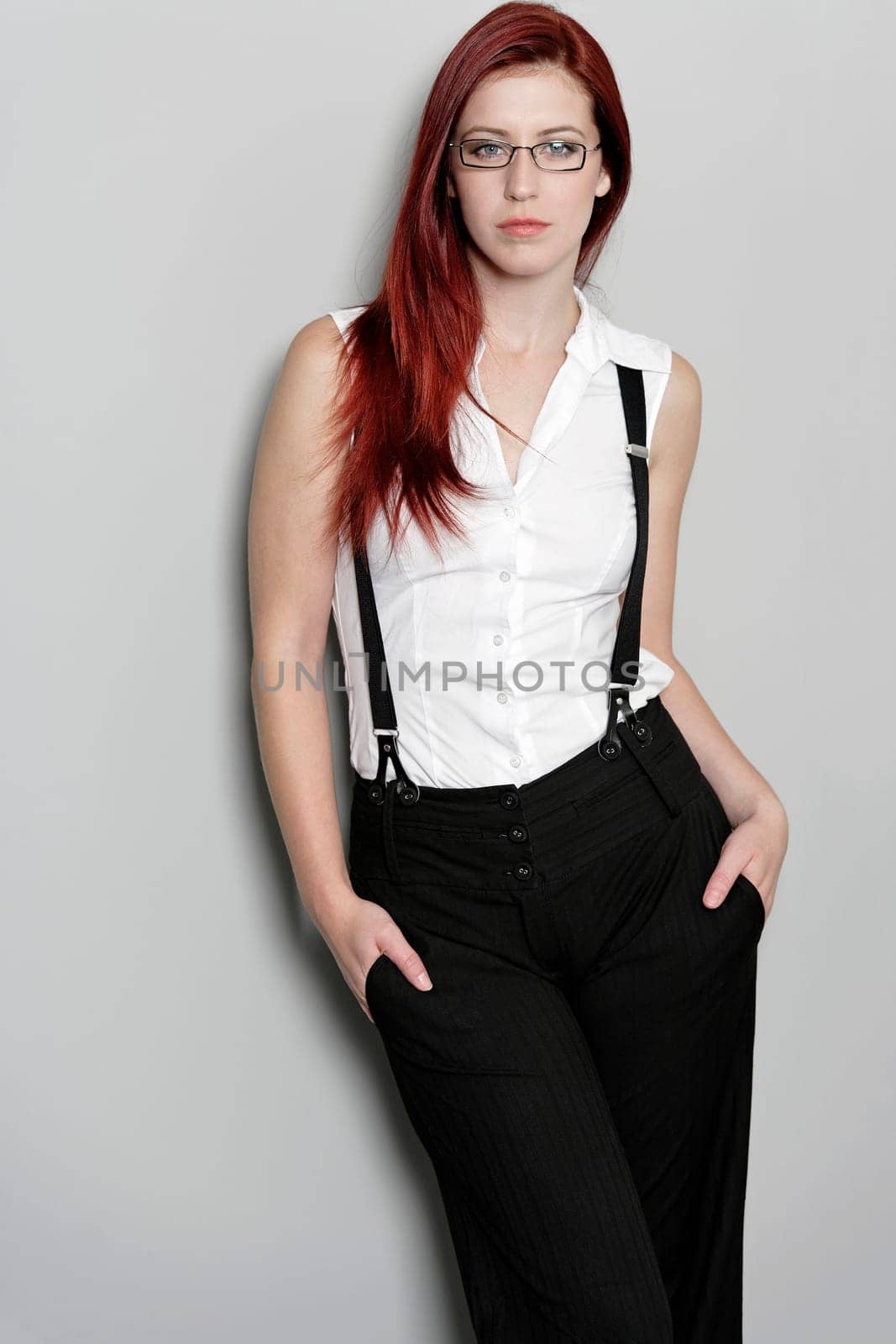 Beautiful young woman in smart business clothes in fashion style pose