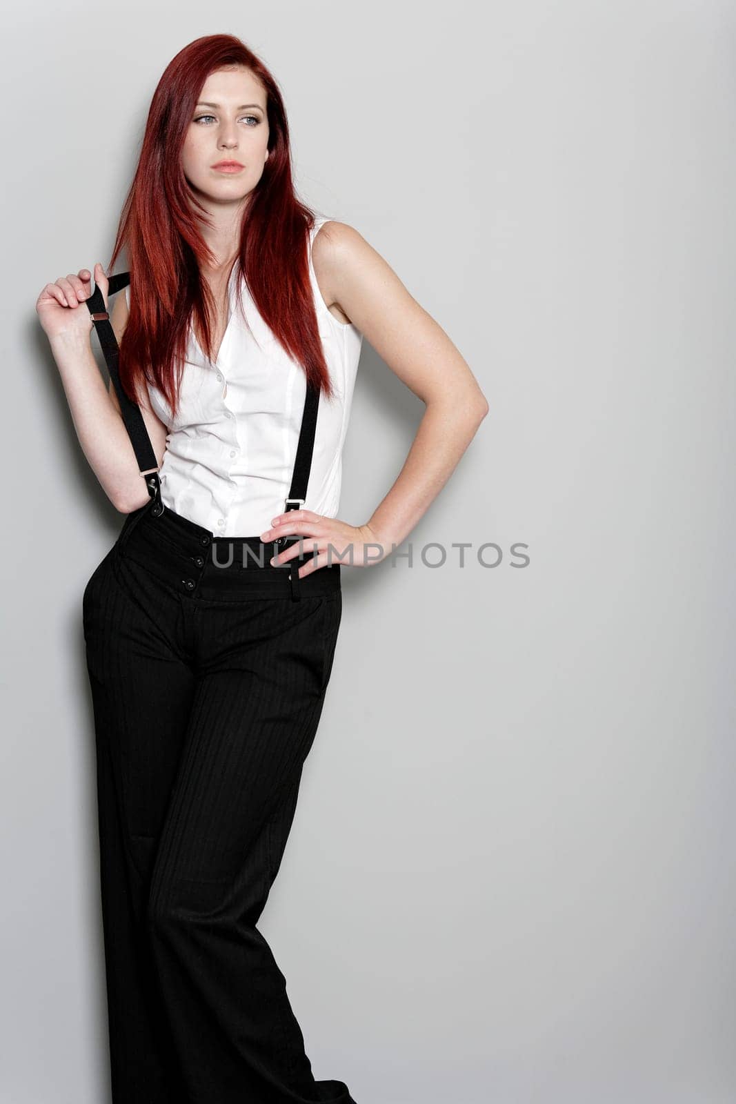 Beautiful young woman in smart business clothes in fashion style pose