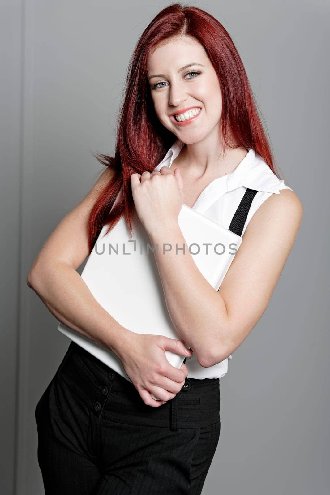 Professional business woman holding a white laptop at work